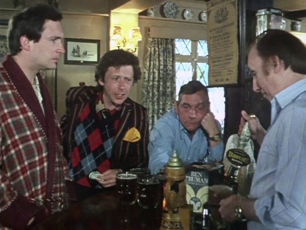 Scene from the BBC mini series, showing Arthur Dent (Simon Jones) and Ford Perfect (David Dixon) standing at the bar and waiting for pints of bitters, poured through a beer engine and served in dimpled mugs.